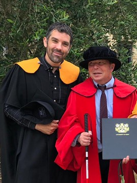 Dr Howard Leicester MBE receiving an additional honorary doctorate from the University of Kent, accompanied by regular Make Things Accessible contributor, Ben Watson.