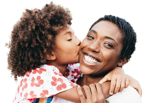 Young Black girl kissing adoptive Black mother on cheek