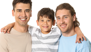 A male same-sex couple standing either side of their adopted son